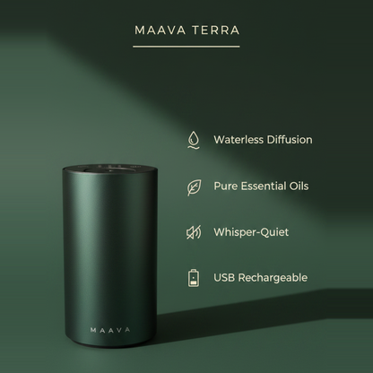 A matte dark green cylindrical essential oil diffuser labeled MAAVA TERRA, shown on a matching dark green background with feature callouts: waterless diffusion, pure essential oils, whisper-quiet, and USB rechargeable.